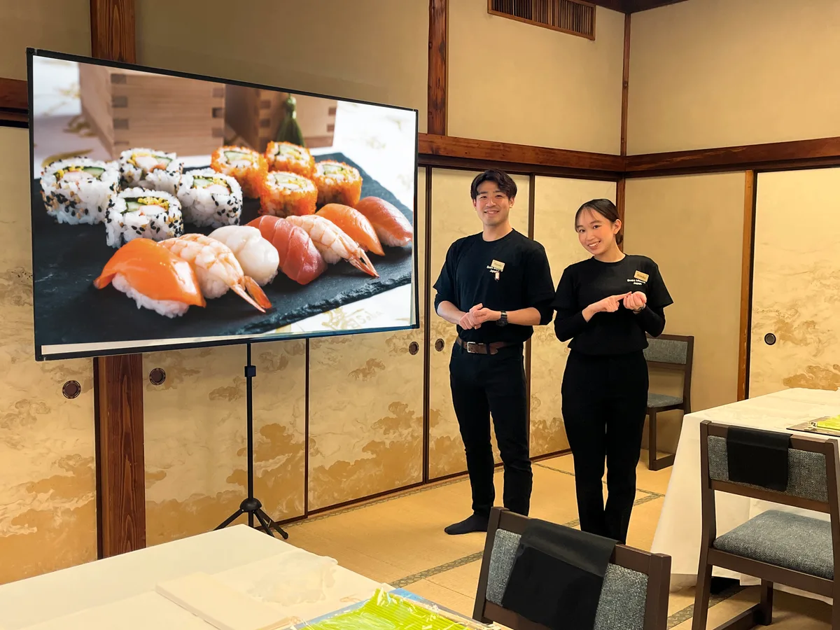 Instructors presenting at a tatami hall offsite venue